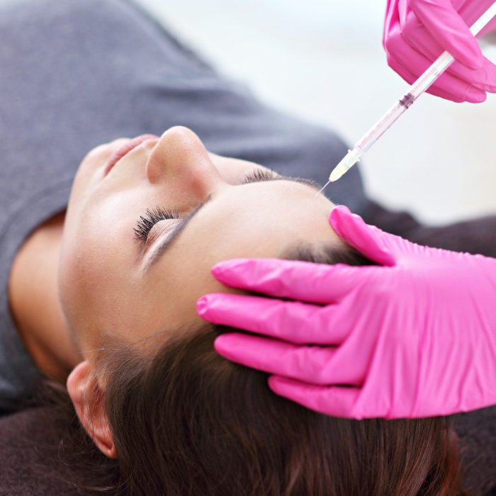 attractive young woman gets cosmetic face injection